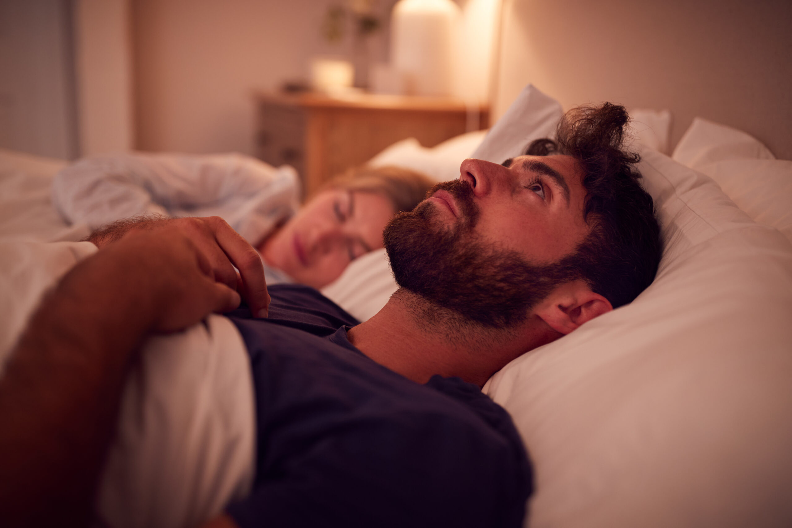 man sleeping on bed