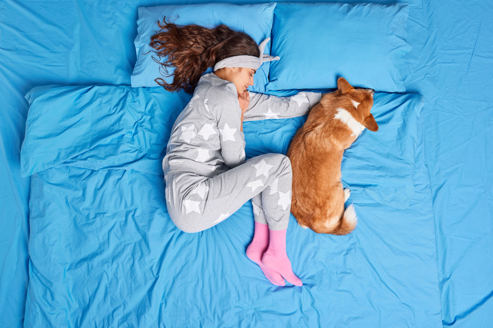 woman and pet sleep together