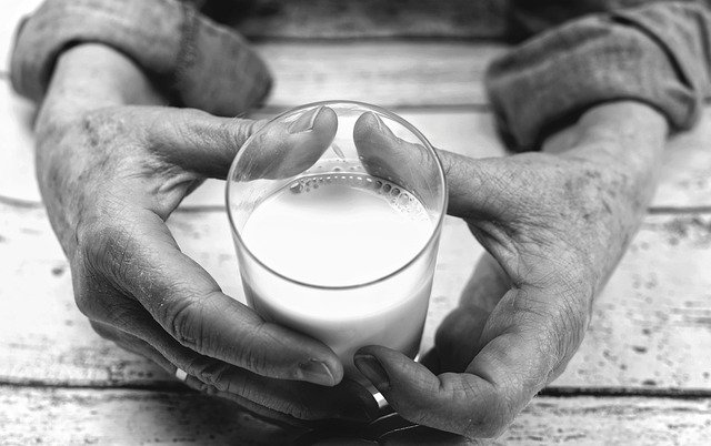 Person Holding Glass of Milk