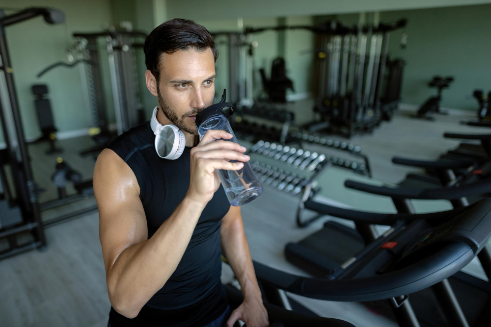 man drinking water in Gym